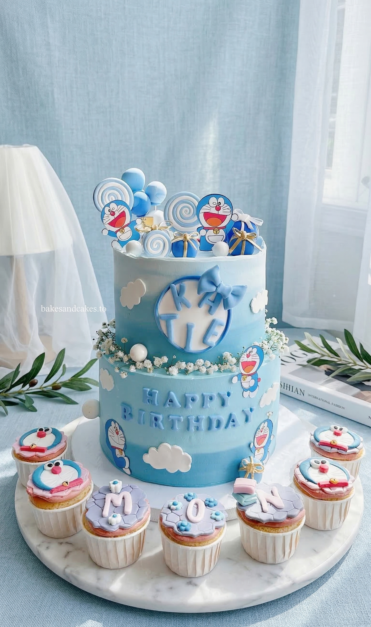 Doraemon tiered birthday cake with blue robot cat character decorations by Bakes & Cakes